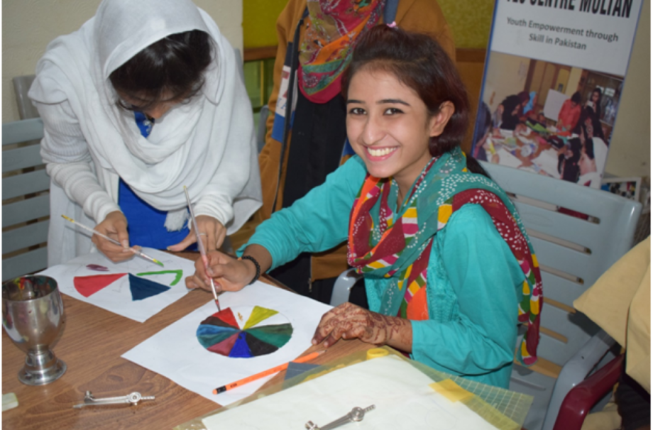Young girl enjoying the color session at YES Center, Multan